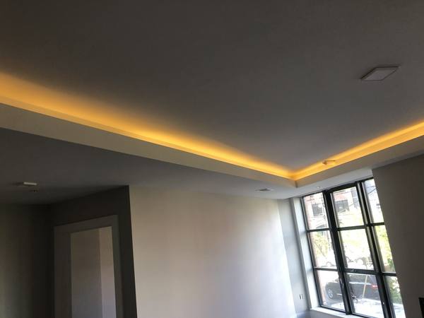 Warm LED cove accent lighting installed in ceiling reveal